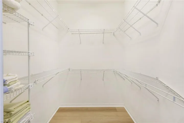 Walk in closet featuring light wood-style flooring