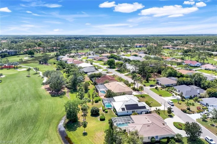 Aerial view of residential area featuring a local golf course