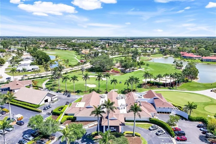 Aerial perspective of suburban area with a nearby body of water and a golf club