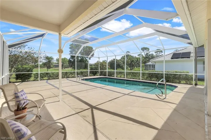 Outdoor pool featuring a patio and glass enclosure