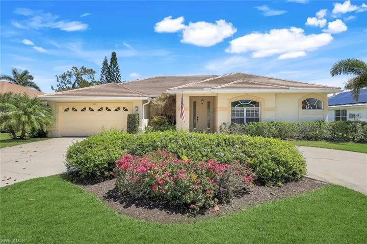 Single story home with a garage, driveway, a tiled roof, and stucco siding