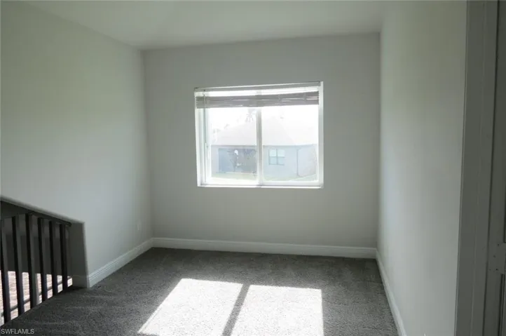 Unfurnished room featuring carpet flooring
