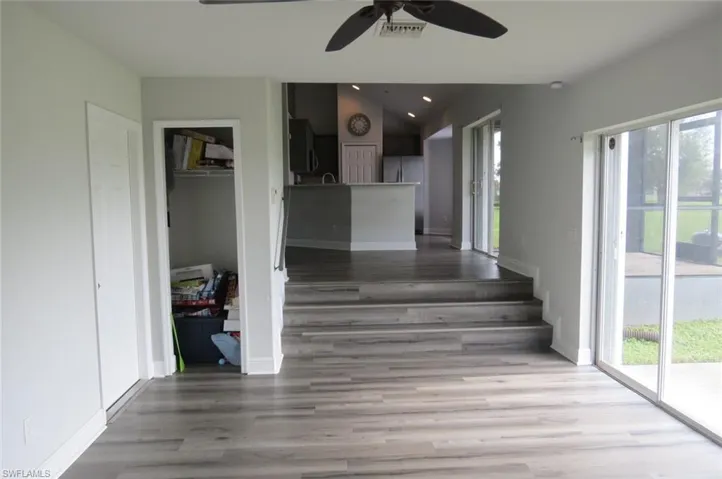 Hallway featuring light hardwood / wood-style flooring and lofted ceiling