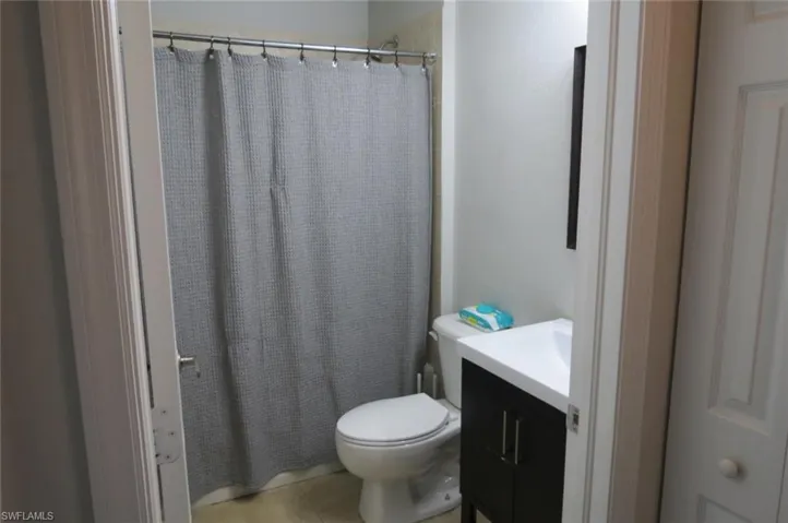 Bathroom with tile patterned flooring, vanity, and toilet