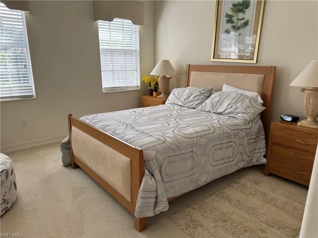 Bedroom featuring light carpet