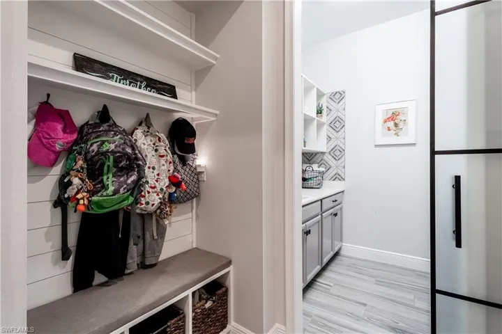 Mudroom featuring light wood-style floors and baseboards