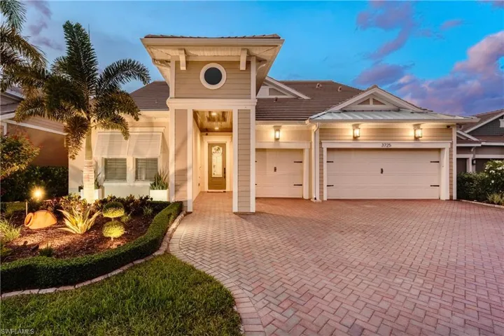 View of front of house featuring decorative driveway and a garage