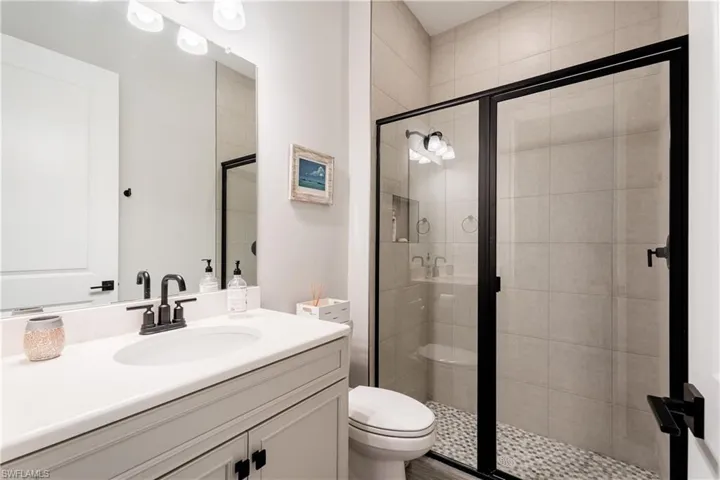Bathroom with vanity and a stall shower