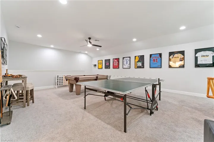Game room featuring light colored carpet, recessed lighting, ceiling fan, and lofted ceiling