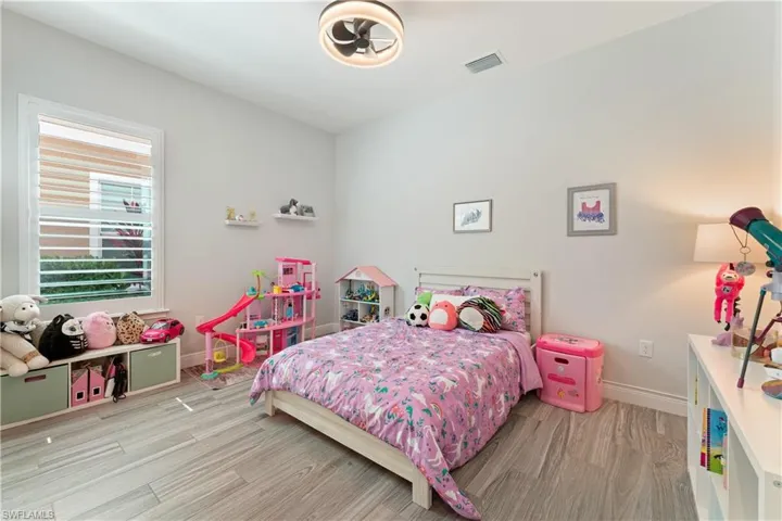 Bedroom featuring light wood-type flooring and baseboards