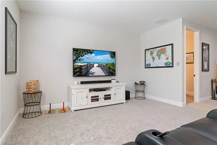 Living room with light carpet and baseboards