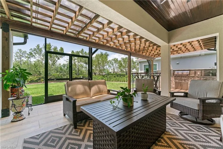 Sunroom / solarium with a pergola, an outdoor living space, and a patio
