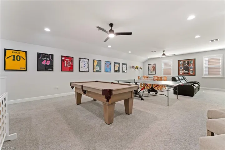 Rec room featuring light carpet, pool table, ceiling fan, lofted ceiling, and recessed lighting