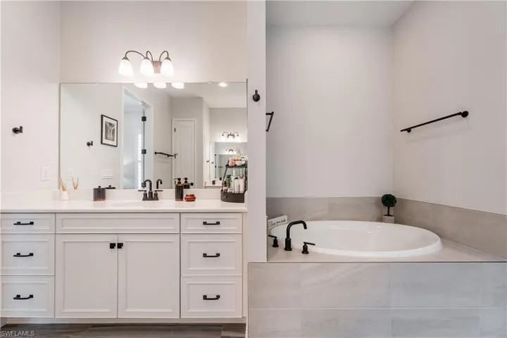 Full bathroom featuring a bath and vanity