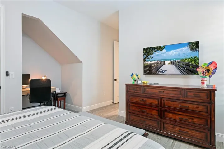 Bedroom featuring a desk and light wood-style flooring
