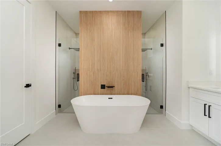 Bathroom with plus walk in shower, vanity, and tile patterned flooring