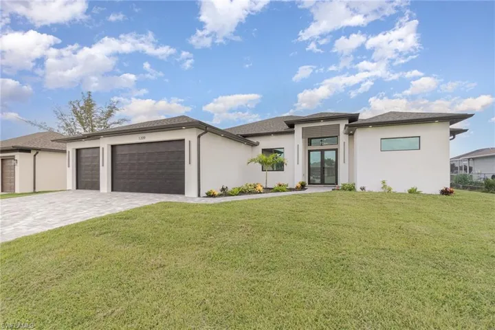 Prairie-style home with a garage and a front yard