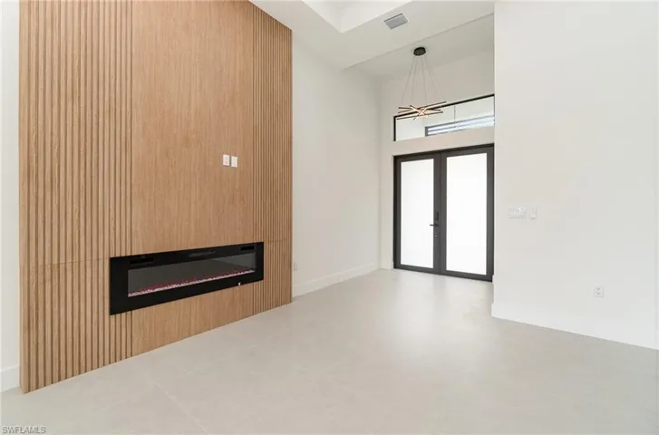 Tiled entryway featuring french doors