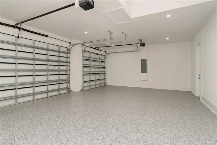 Garage with electric panel and a garage door opener