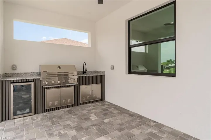 View of patio with area for grilling and exterior kitchen