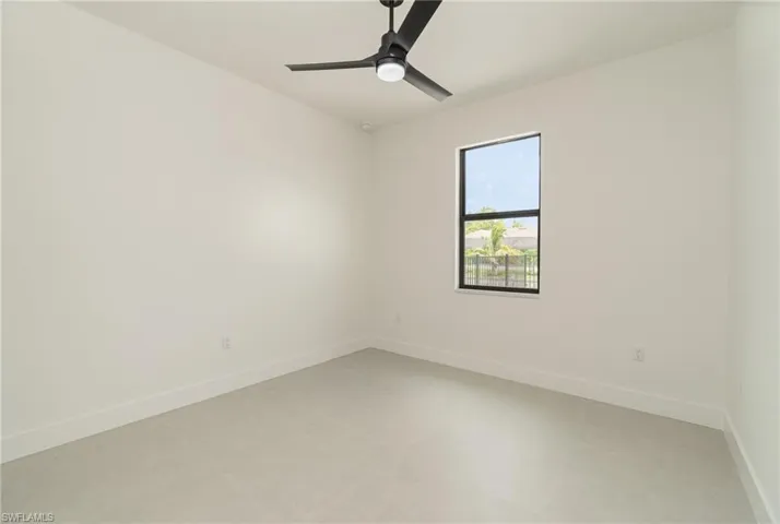 Tiled spare room with ceiling fan
