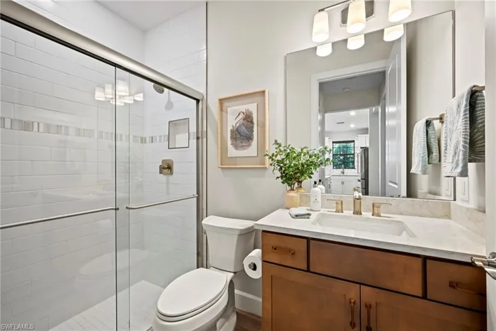 Bathroom featuring a stall shower and vanity