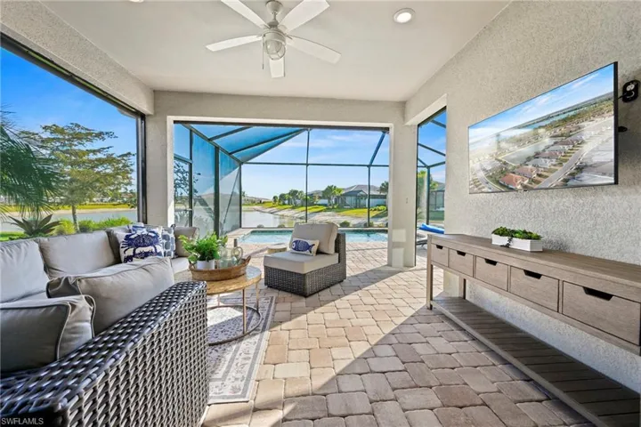 Sunroom featuring a patio, an outdoor hangout area, a ceiling fan, and plenty of natural light