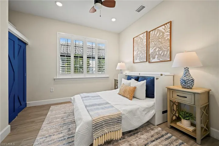Bedroom with light wood-type flooring, a ceiling fan, and recessed lighting