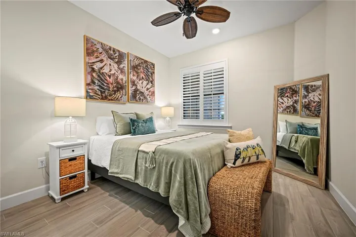 Bedroom featuring wood tiled floors, ceiling fan, and recessed lighting