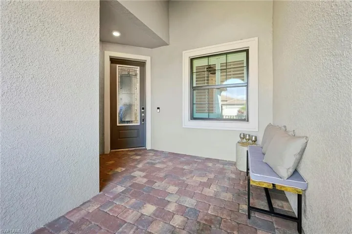 Property entrance featuring stucco siding