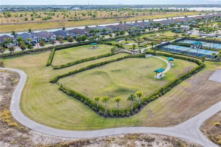 Aerial view of property and surrounding area featuring nearby suburban area