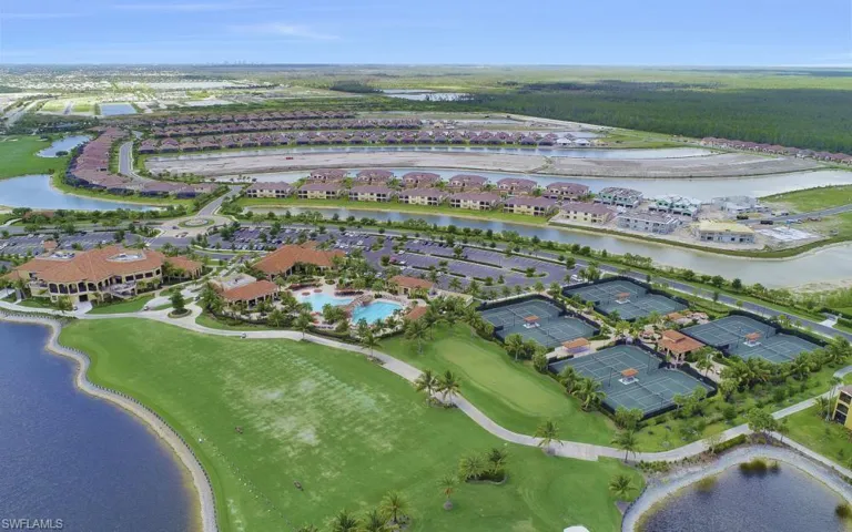 Aerial view of property and surrounding area featuring a large body of water and nearby suburban area