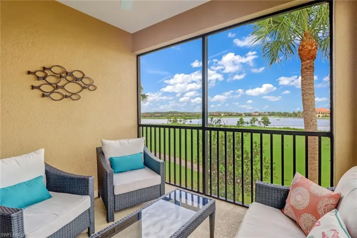 Sunroom / solarium with a water view and outdoor lounge area