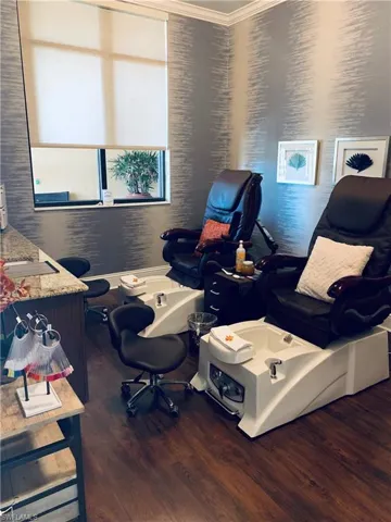 Office area with wood finished floors and ornamental molding
