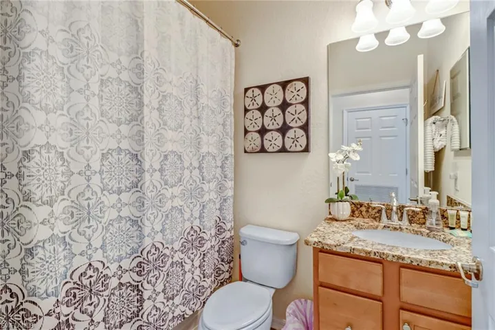 Bathroom with vanity and a shower with shower curtain