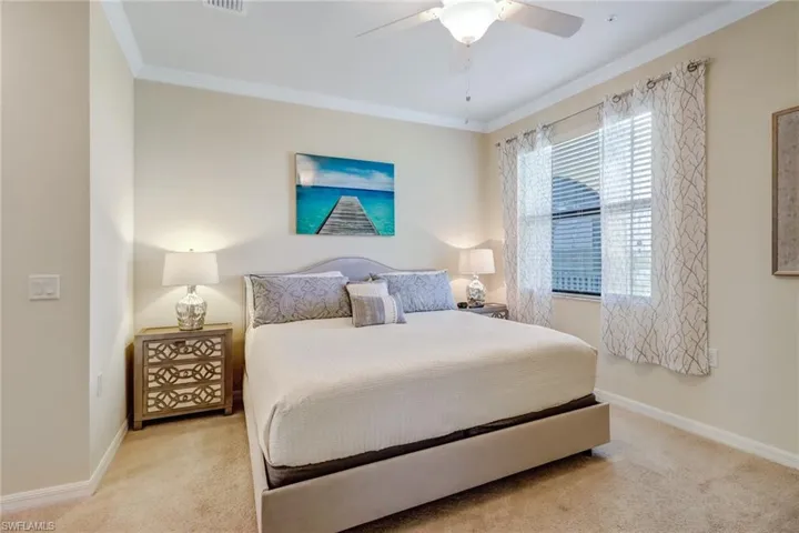 Bedroom featuring carpet flooring, crown molding, and a ceiling fan