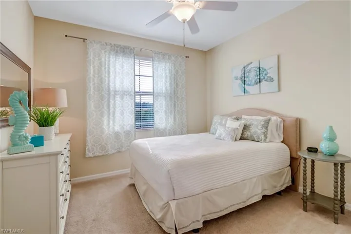 Bedroom with light colored carpet and ceiling fan