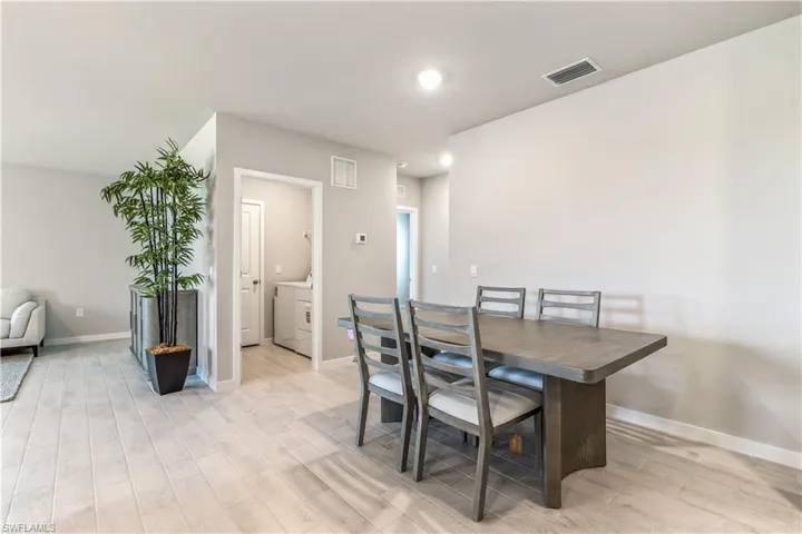 Dining room with light wood-style floors and baseboards