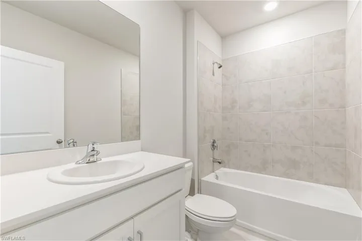 Bathroom featuring shower / bath combination and vanity