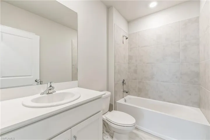 Bathroom with shower / bath combination and vanity