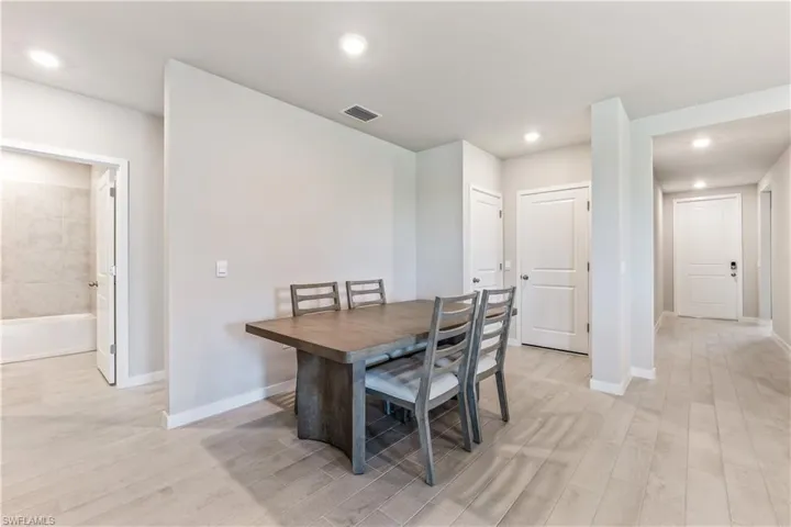 Dining space featuring recessed lighting and light wood finished floors