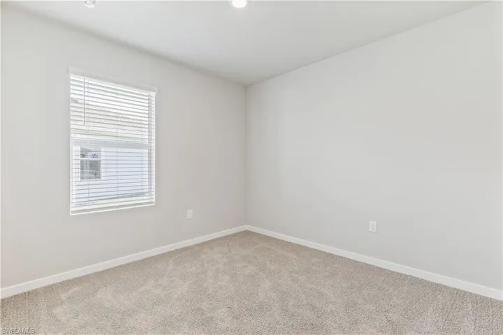 Empty room with carpet and recessed lighting