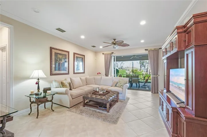 Living area featuring ornamental molding, light tile patterned floors, a ceiling fan, and recessed lighting