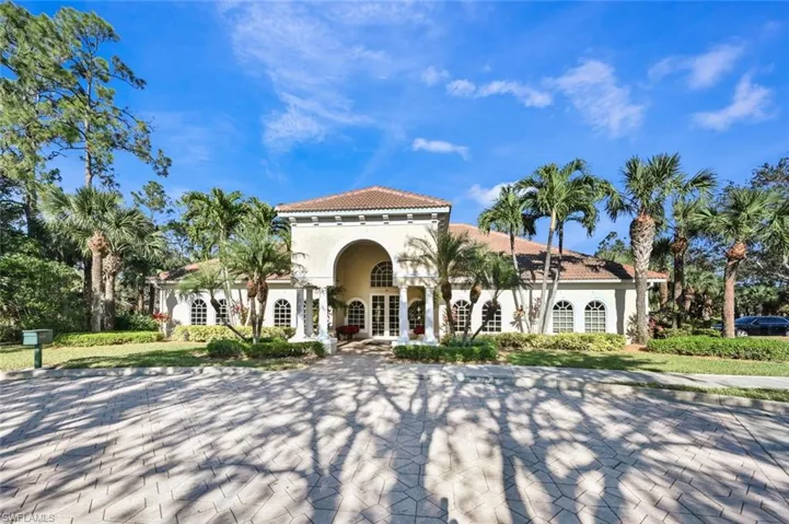 View of front of house with french doors, stucco siding, and a tile roof