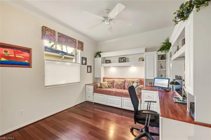Office featuring crown molding, dark wood-style flooring, and ceiling fan