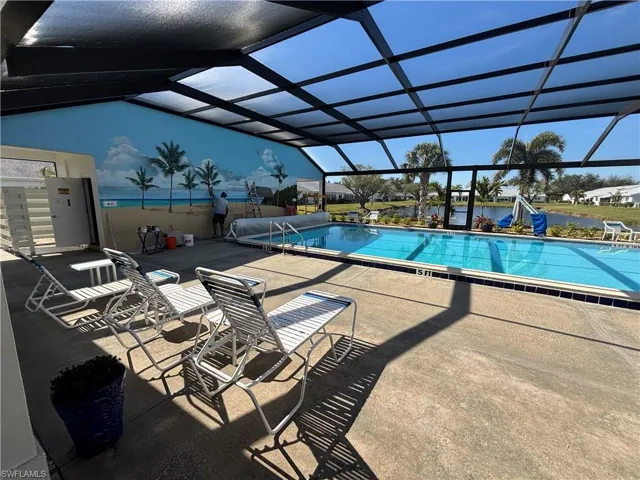 Community pool with glass enclosure and a patio