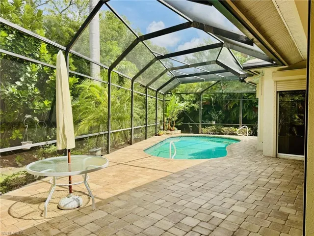 Swimming pool featuring a patio area and a lanai