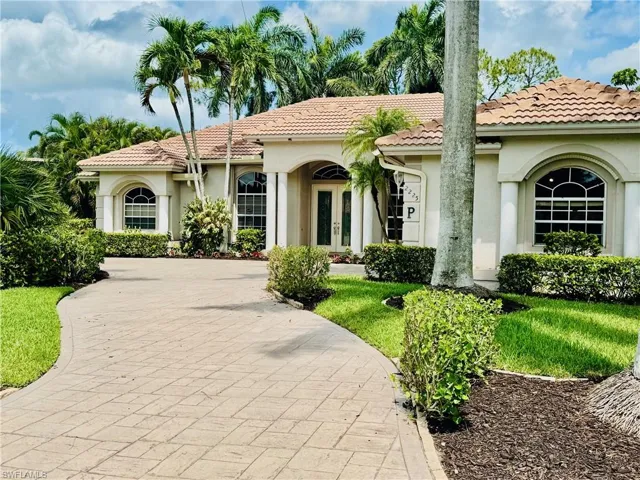 Mediterranean / spanish-style house featuring french doors, stucco siding, a tiled roof, and a front lawn