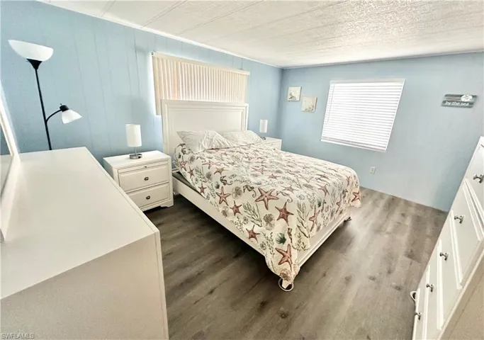 Bedroom featuring dark hardwood / wood-style flooring and a textured ceiling