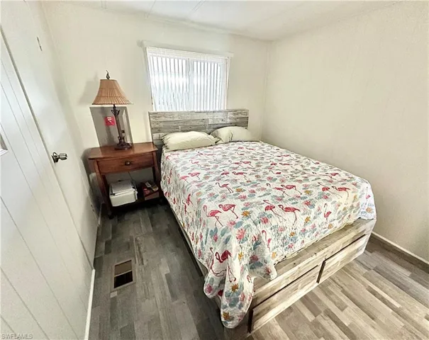 Bedroom with hardwood / wood-style flooring